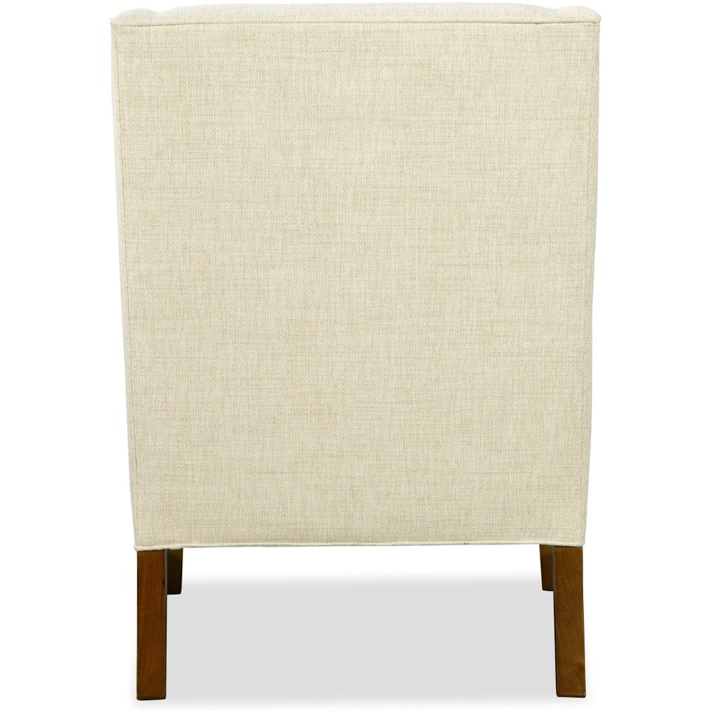 Back view of an accent chair with cream woven fabric upholstery and dark brown wooden legs.