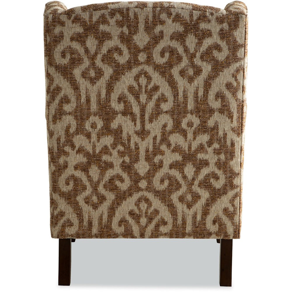 Back view of a wingback armchair upholstered in a beige and brown ikat damask pattern with wooden legs.