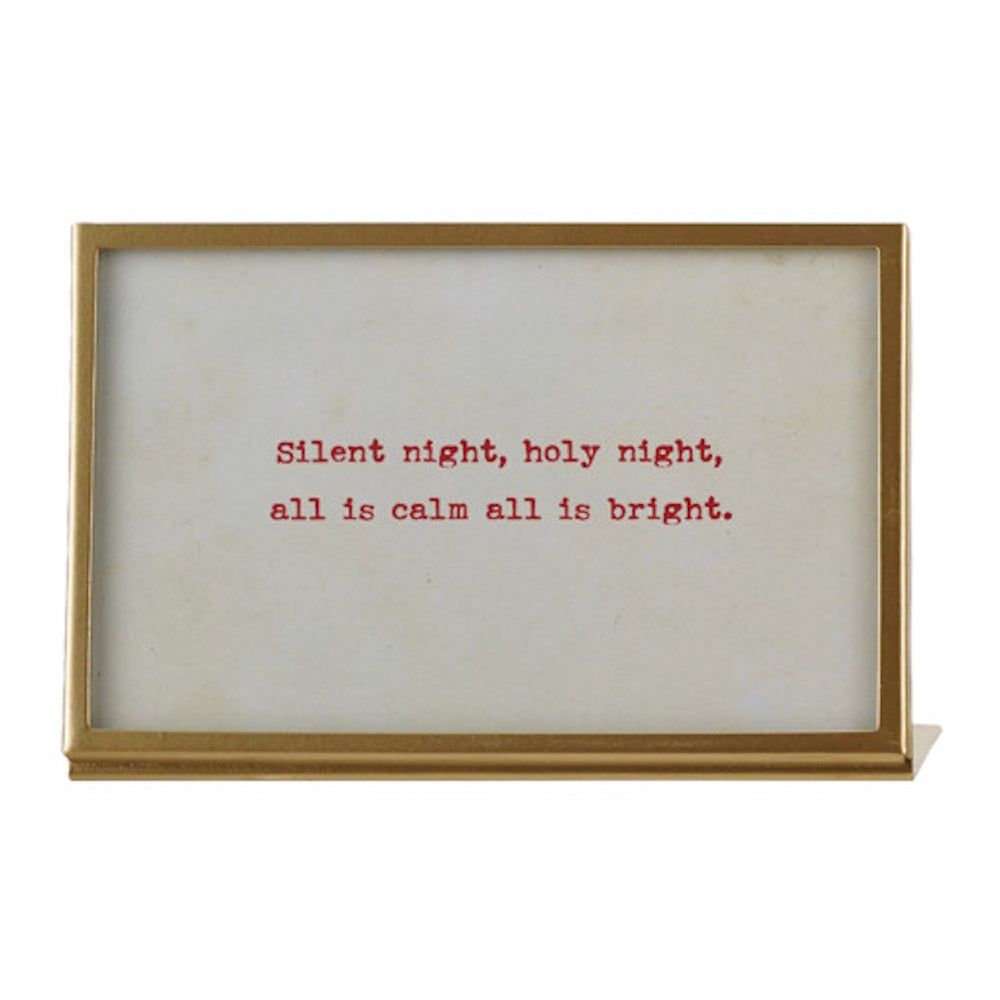 Brass metal framed sign with text reading "Silent night, holy night, all is calm all is bright."