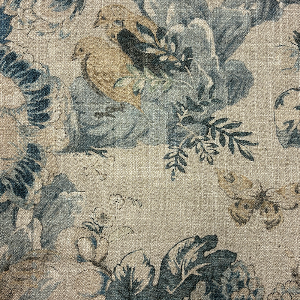 Blue and beige floral fabric with birds and butterfly pattern.