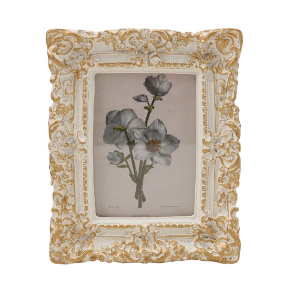 Ornate vintage white and gold baroque photo frame displaying a botanical print of white flowers.