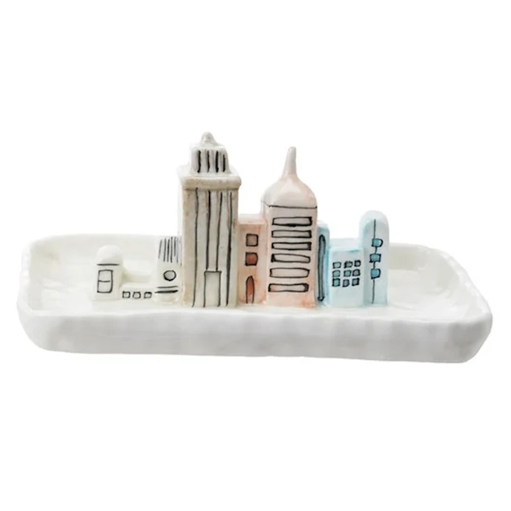 White stoneware trinket dish featuring 3D miniature hand-painted cityscape buildings in pastel tones.