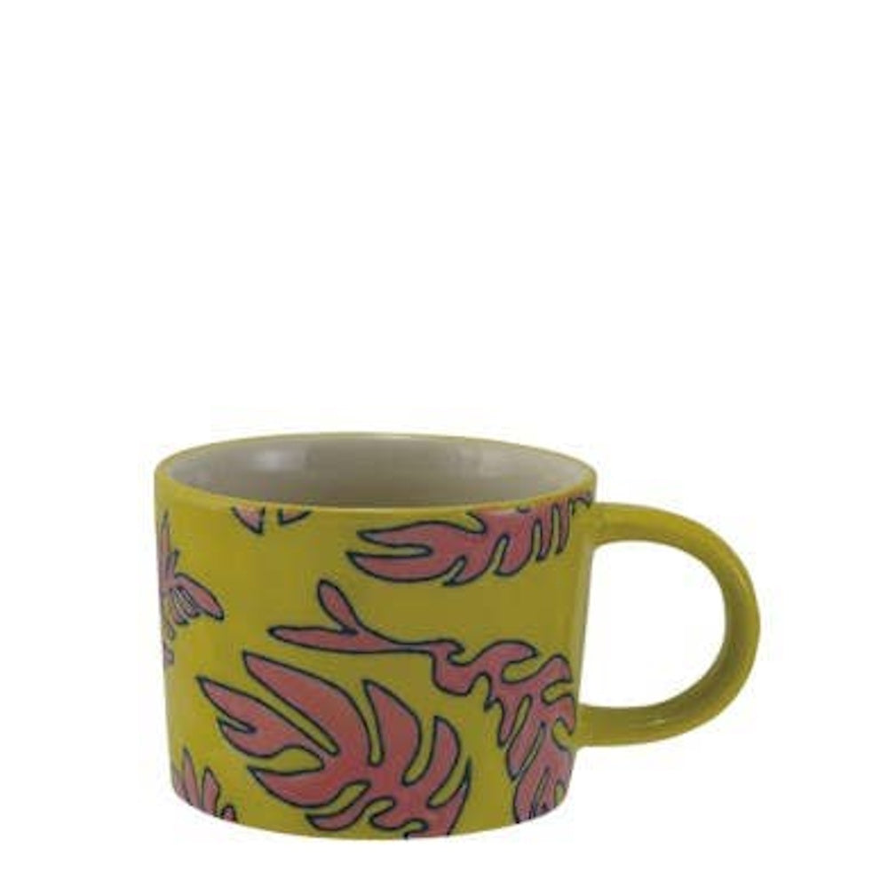 Yellow stoneware mug featuring a pink tropical leaf pattern with dark outlines.