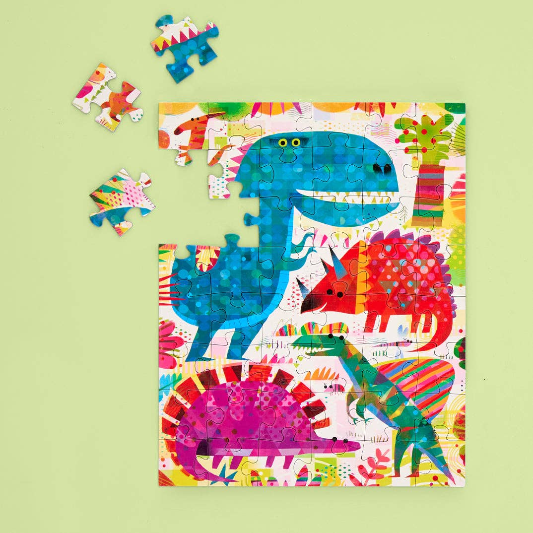 Colorful dinosaur puzzle on a green background