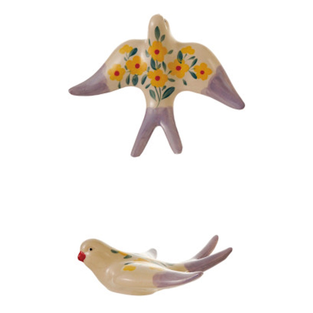 Two ceramic bird figures with hand-painted yellow flowers and purple accents on a white background.
