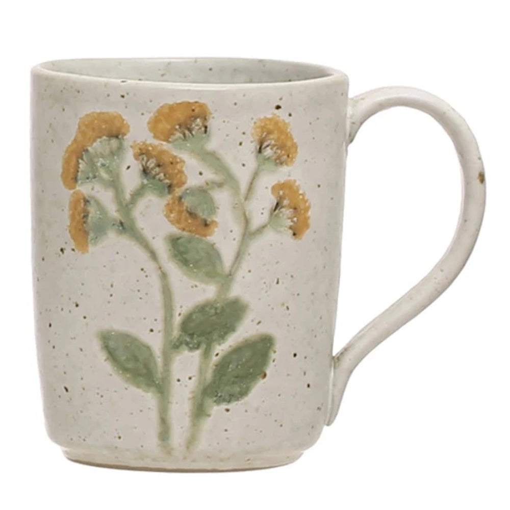Speckled cream stoneware mug featuring embossed botanical stems with green leaves and gold-yellow blossoms.