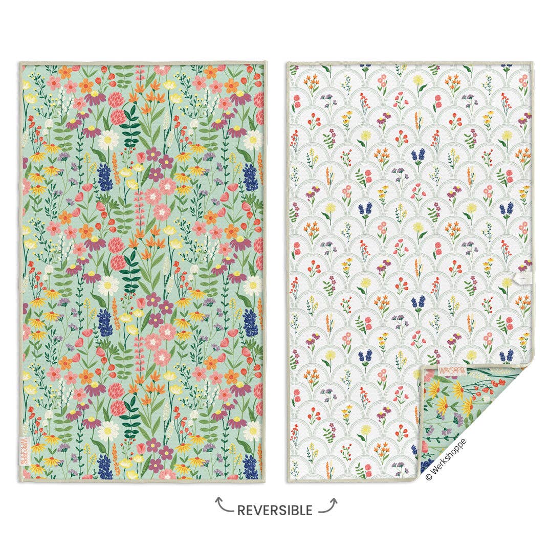Two floral-patterned blankets with a reversible label on a white background