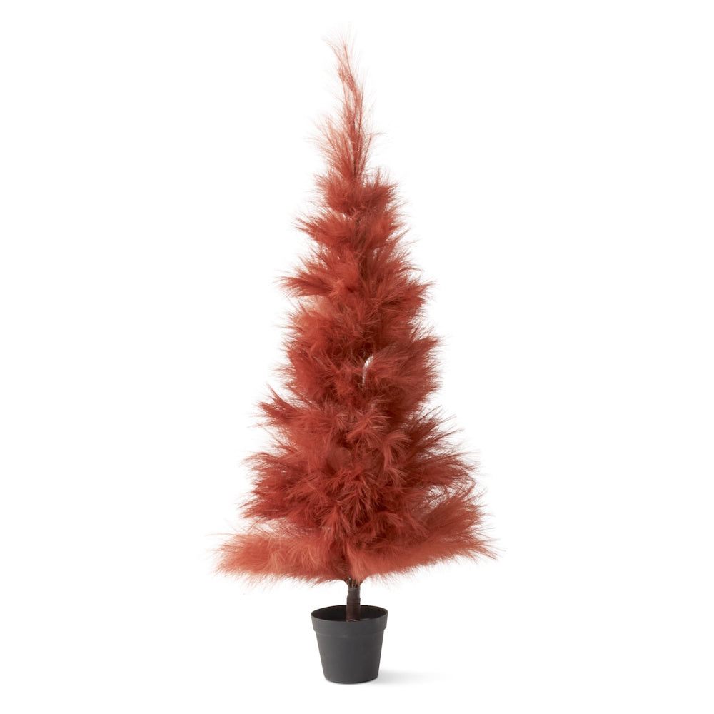 A small, rust-colored tabletop pampas grass tree with fluffy faux pine needles in a black pot.