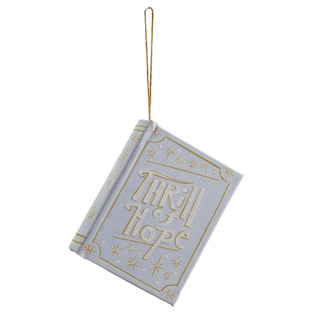 Light blue book ornament with gold details reading "Thrill of Hope" and hanging from a string.