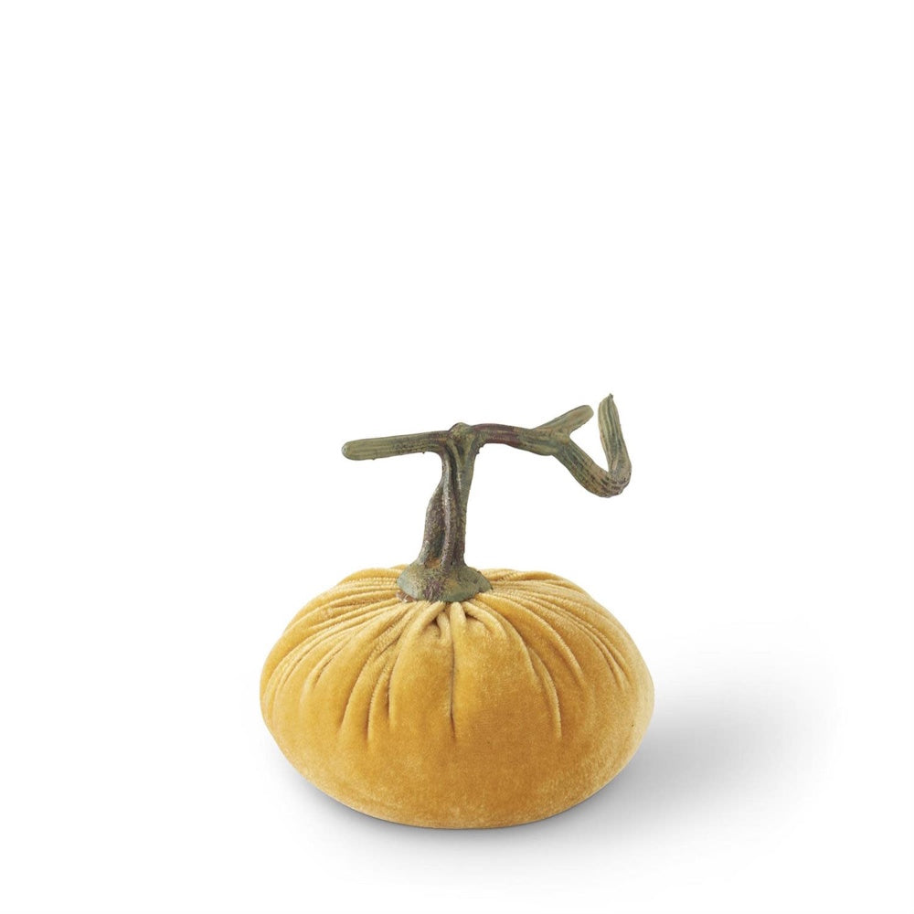 A mustard yellow velvet stuffed pumpkin decor with a curled stem on a white background.