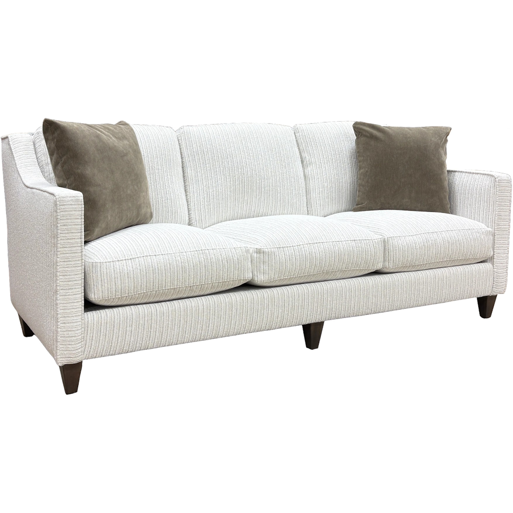 White textured fabric sofa with three seat cushions, gray throw pillows and dark tapered legs.