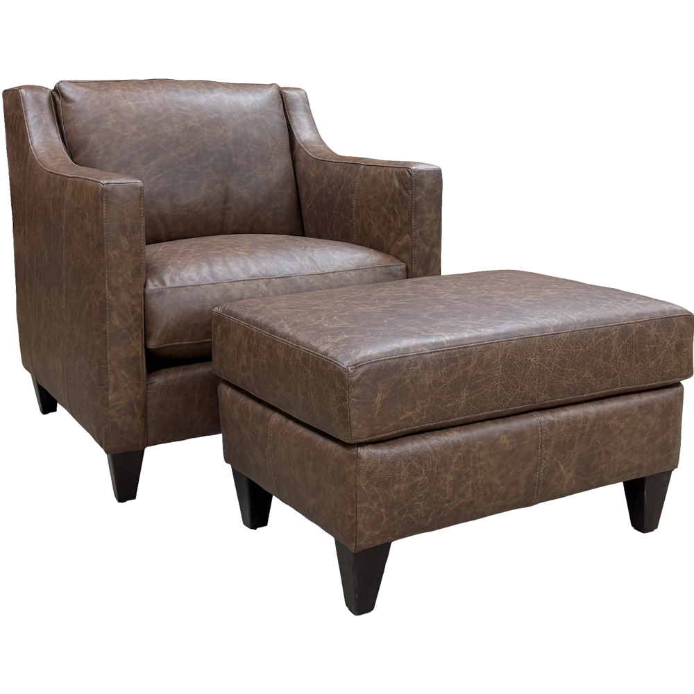 Brown leather accent chair with matching ottoman, loose cushions, track arms and dark tapered legs.