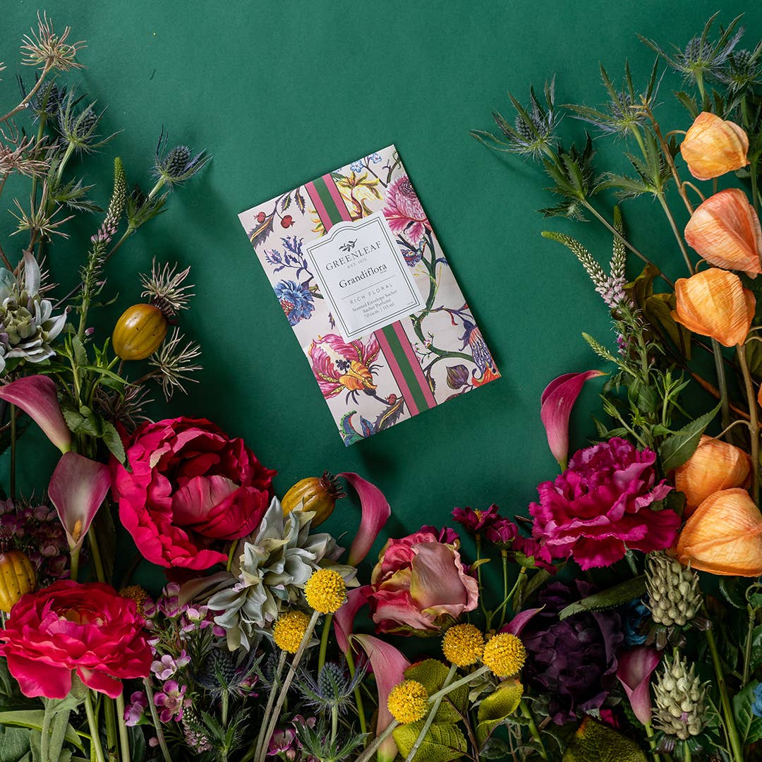 Floral arrangement with a decorative box on a green background