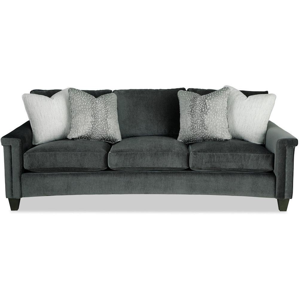 Dark charcoal velvet three-cushion sofa styled with light grey patterned accent pillows.