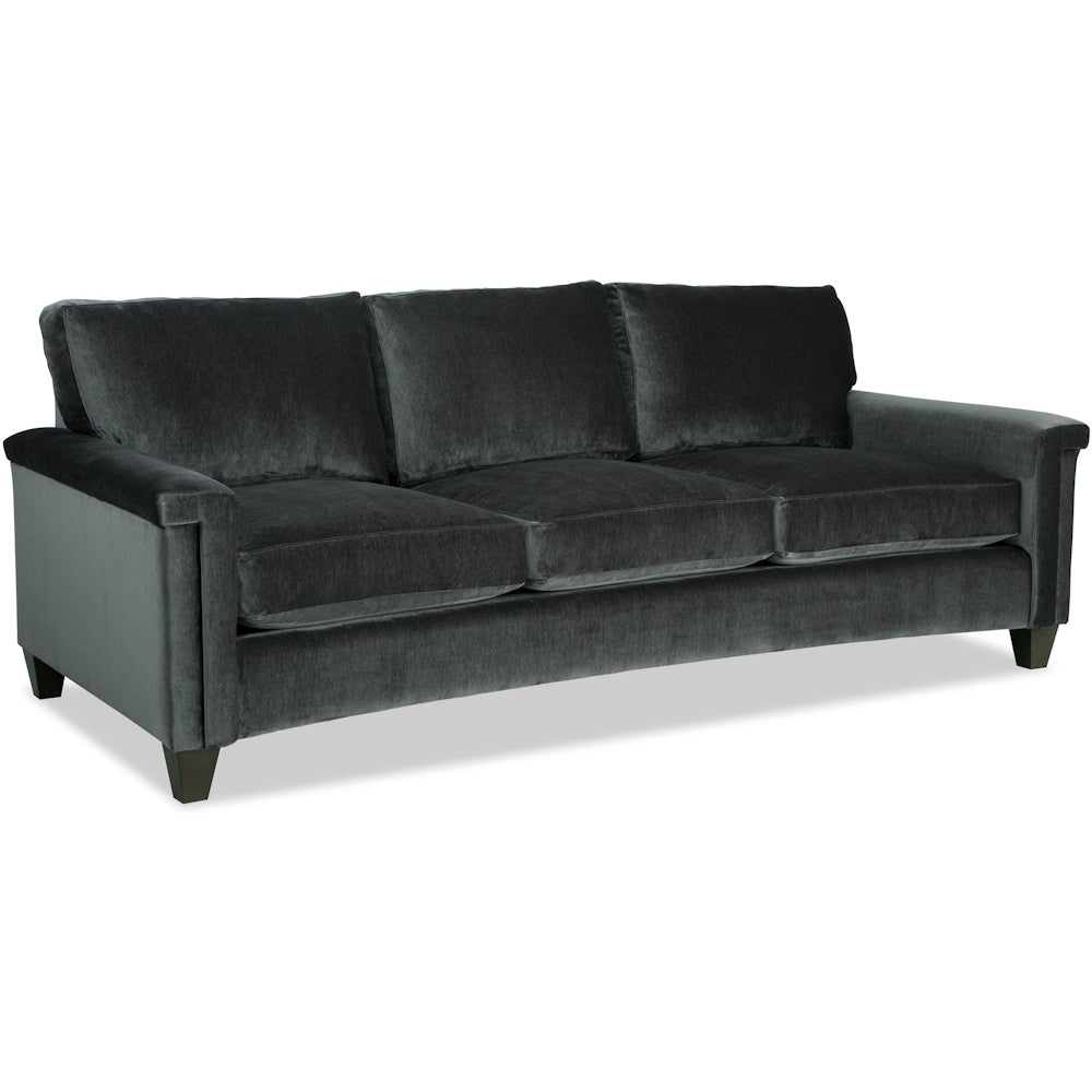 Dark charcoal velvet three-cushion sofa angled to show its plush seat, back cushions, and wooden feet.