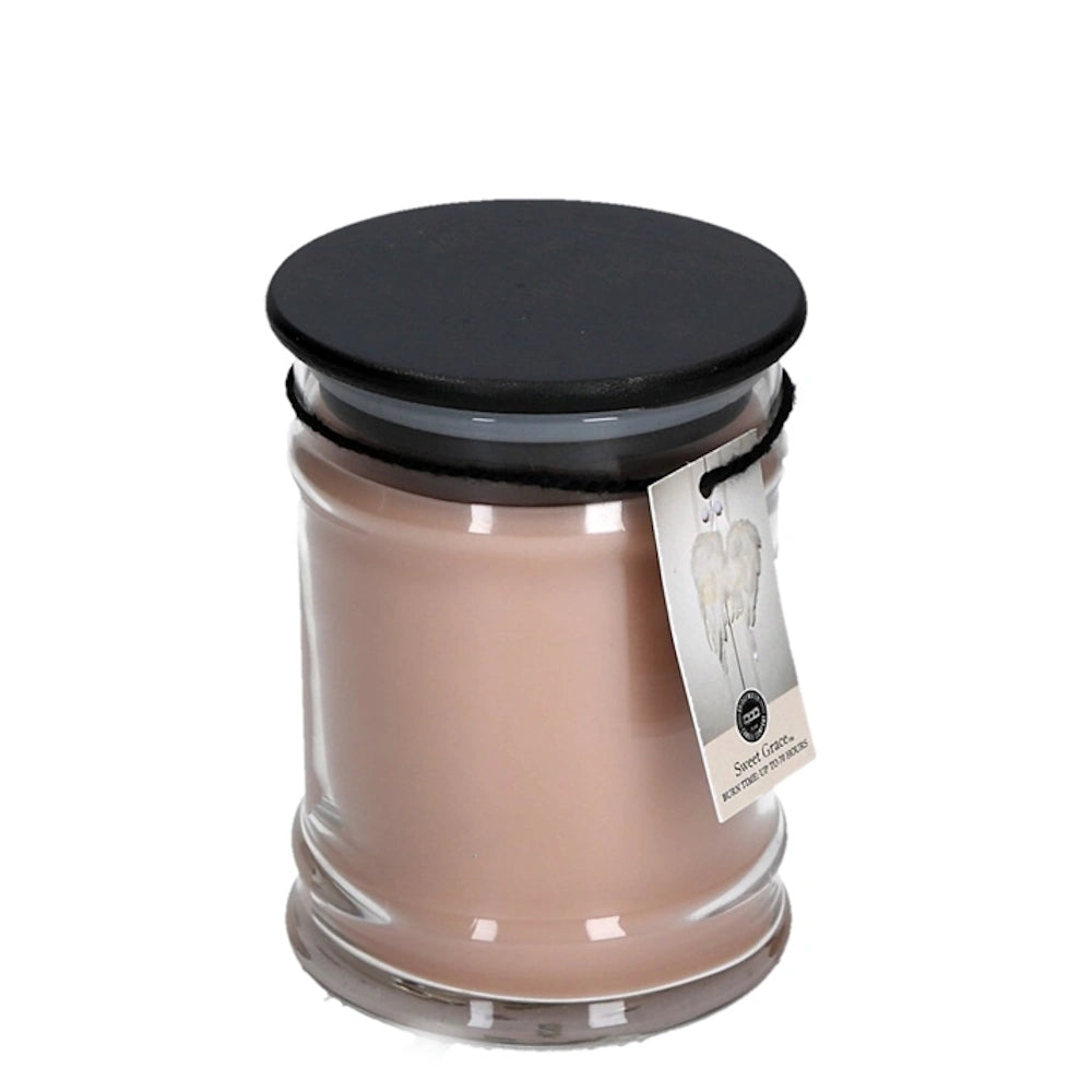 Clear glass jar candle filled with beige wax, black lid, and a hanging Sweet Grace product tag.