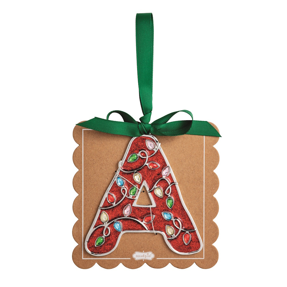Sparkly red Christmas initial ornament letter A mounted on a scalloped brown card with a green hanging ribbon.