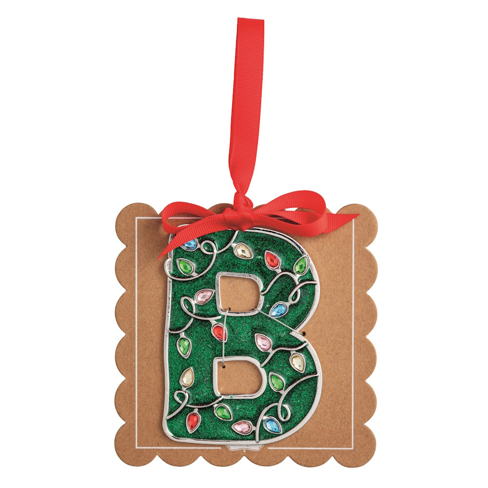 Sparkly green Christmas initial ornament letter B on a scalloped brown card with a red hanging ribbon.