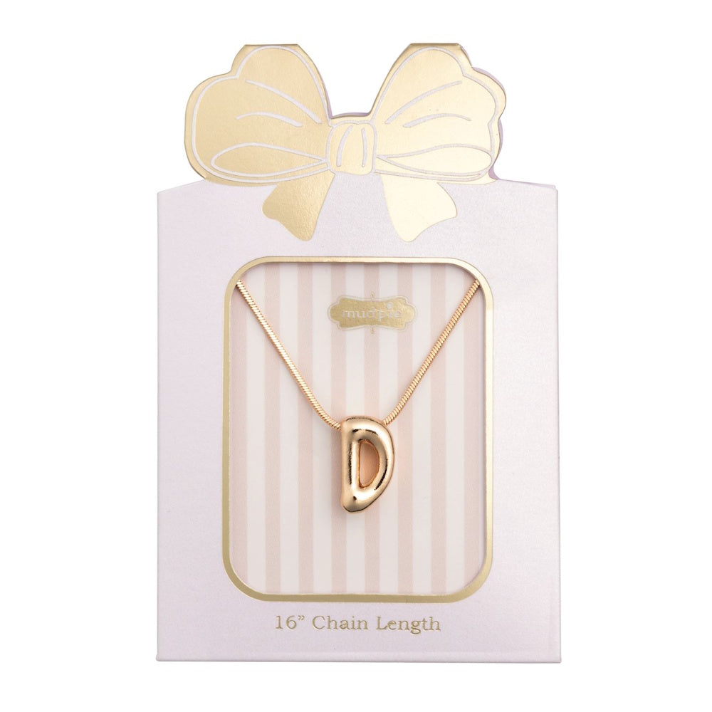 Gold initial "D" pendant necklace on a chain, packaged in a pink gift card topped with a bow.