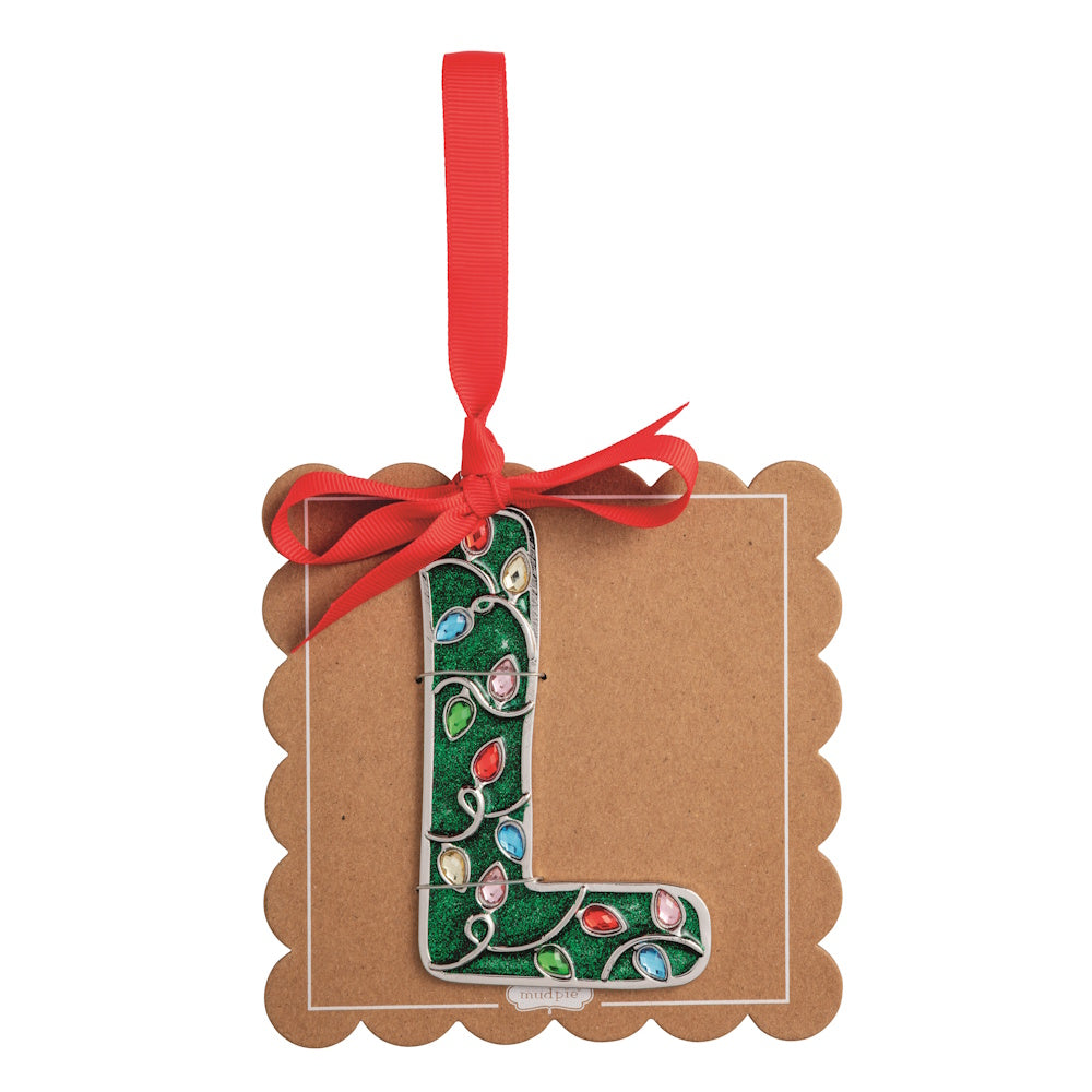 Sparkly green Christmas initial ornament letter L on a scalloped brown card with a red hanging ribbon.
