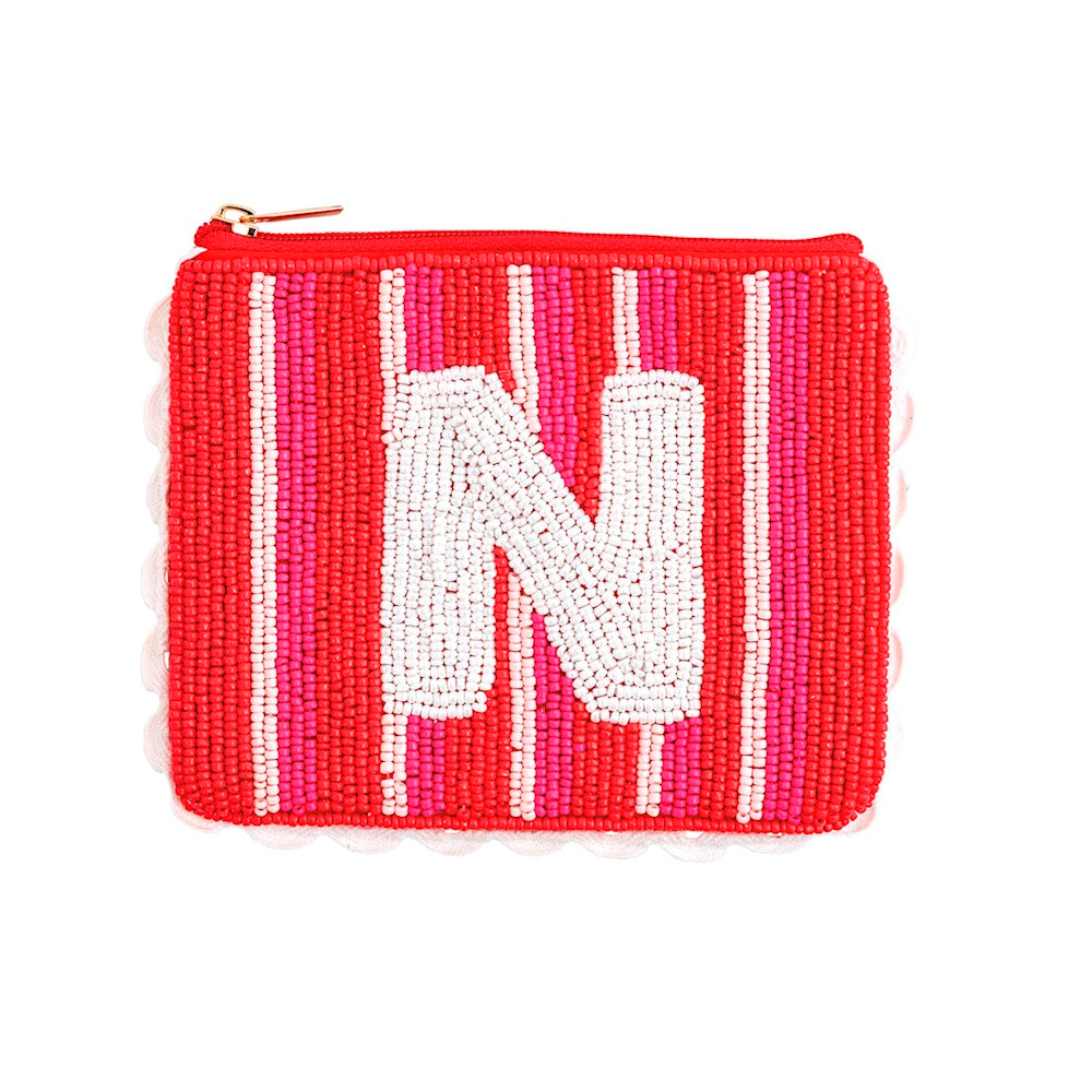Beaded pouch with red and pink stripes, scalloped trim, and a centered white initial letter N.