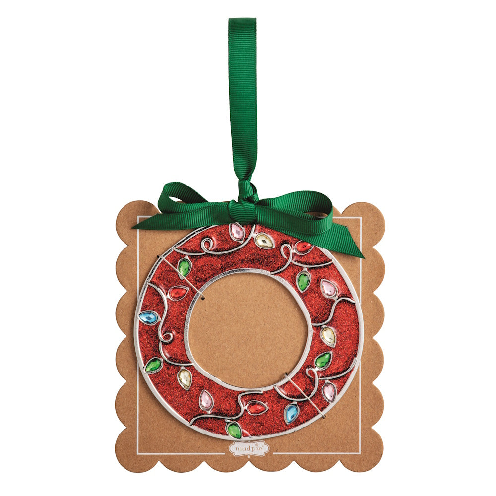 Sparkly red Christmas initial ornament letter O mounted on a scalloped brown card with a green hanging ribbon.