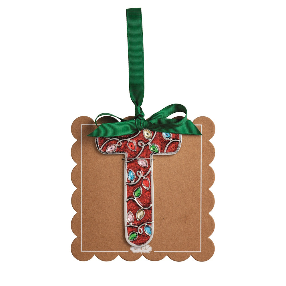 Sparkly red Christmas initial ornament letter T mounted on a scalloped brown card with a green hanging ribbon.