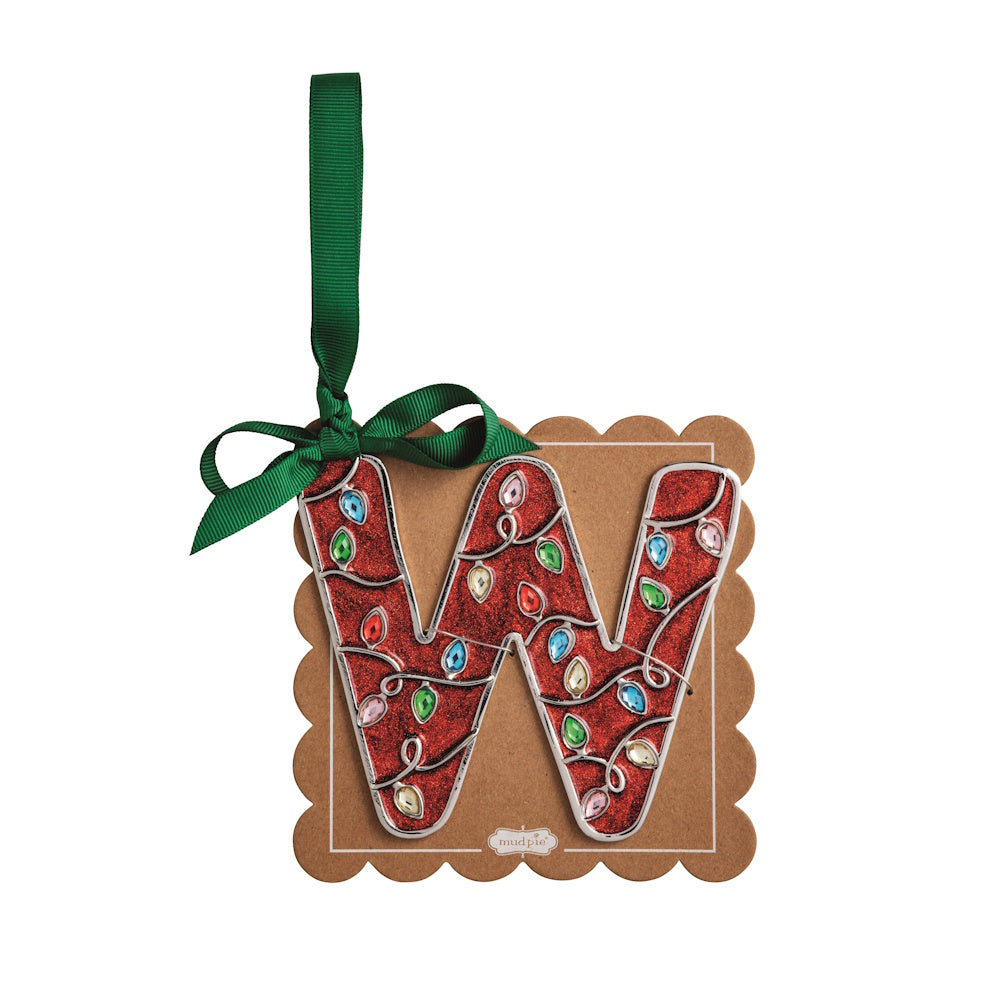 Sparkly red Christmas initial ornament letter W mounted on a scalloped brown card with a green hanging ribbon.