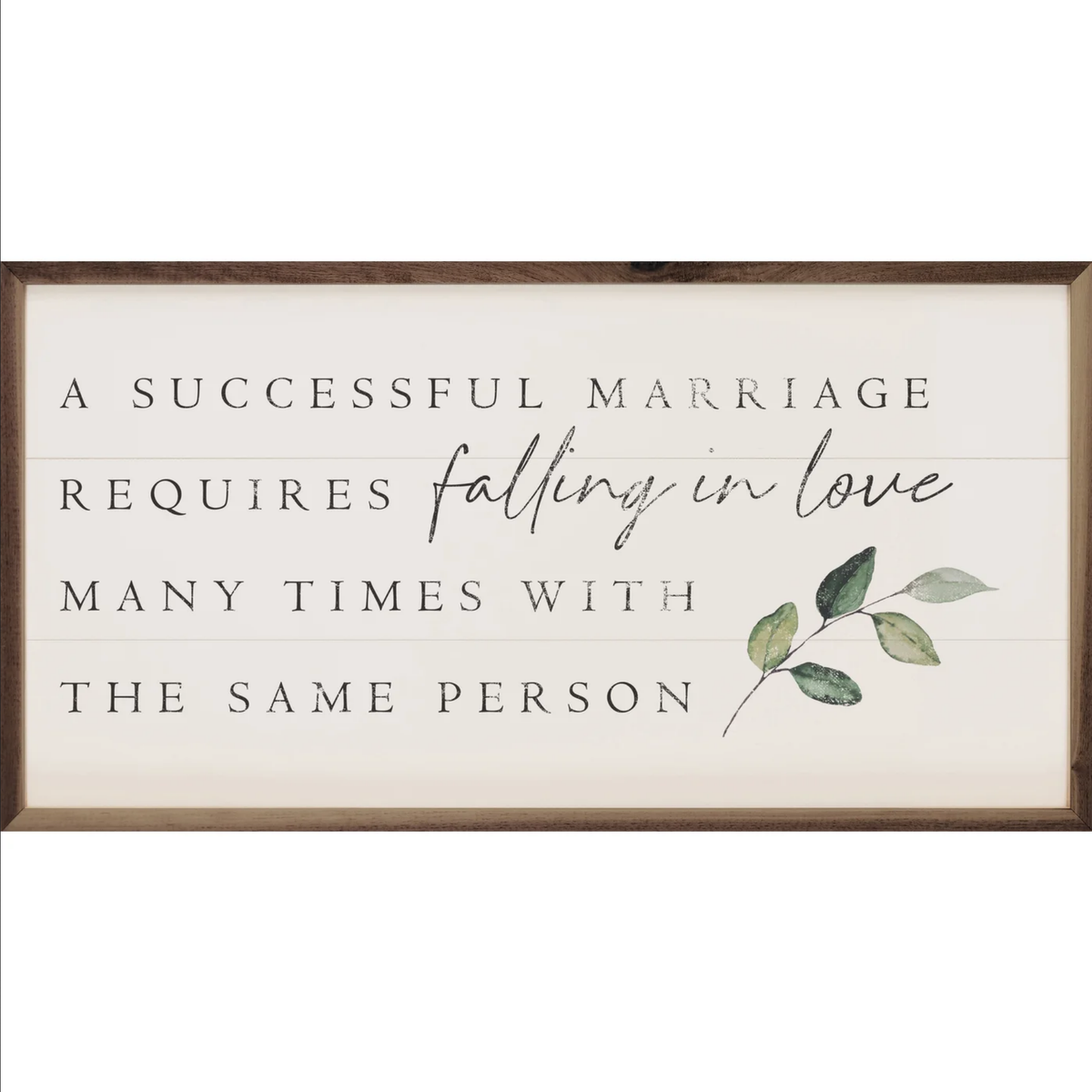 Framed wall sign reading "A successful marriage requires falling in love many times with the same person" with eucalyptus branch art.