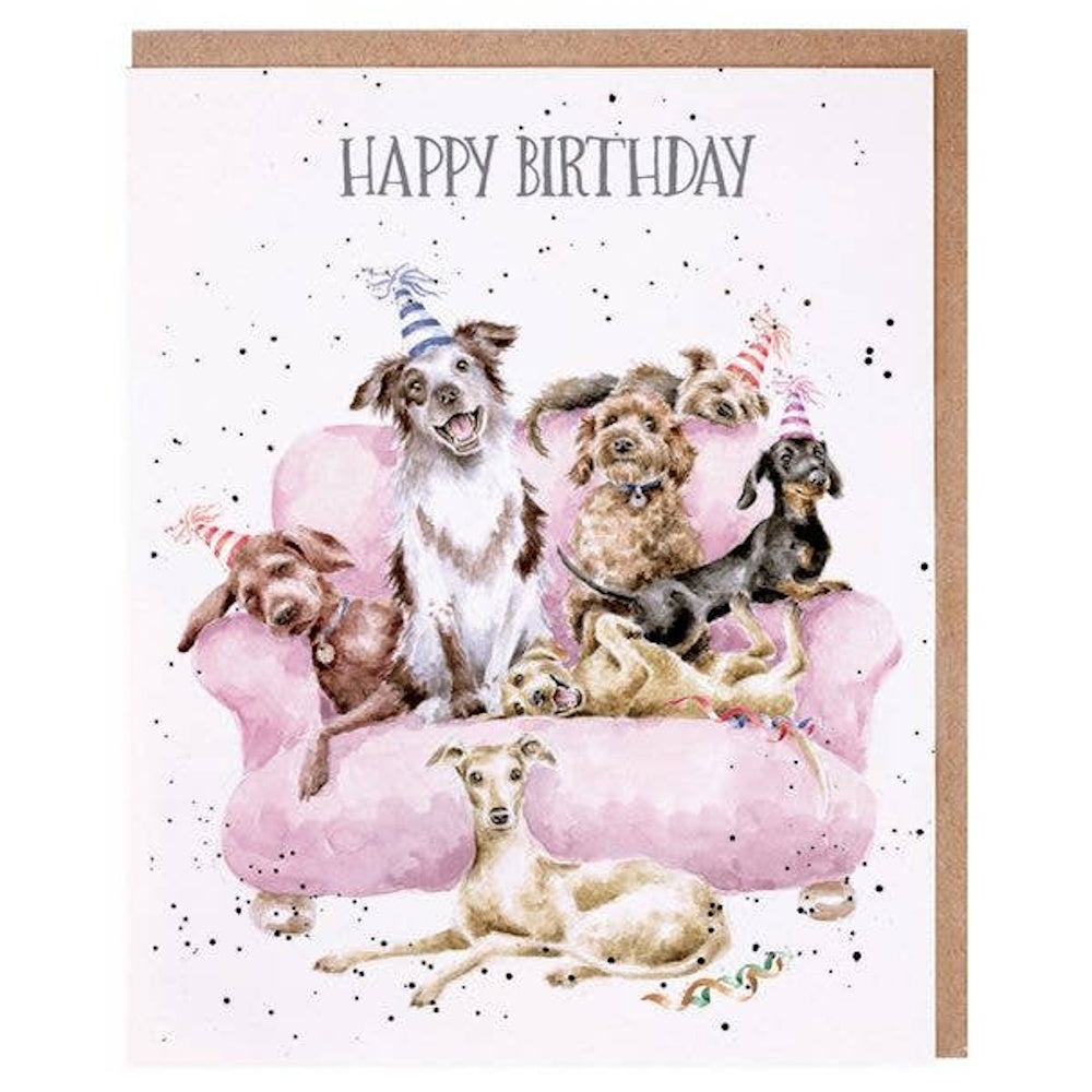 Watercolor illustration of multiple dogs in party hats on a pink sofa with "Happy Birthday" text and black confetti.