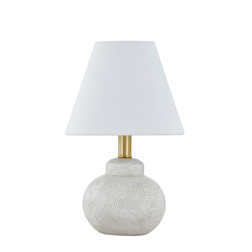 White textured ceramic table lamp with tapered fabric shade and brass metal accent for modern decor.