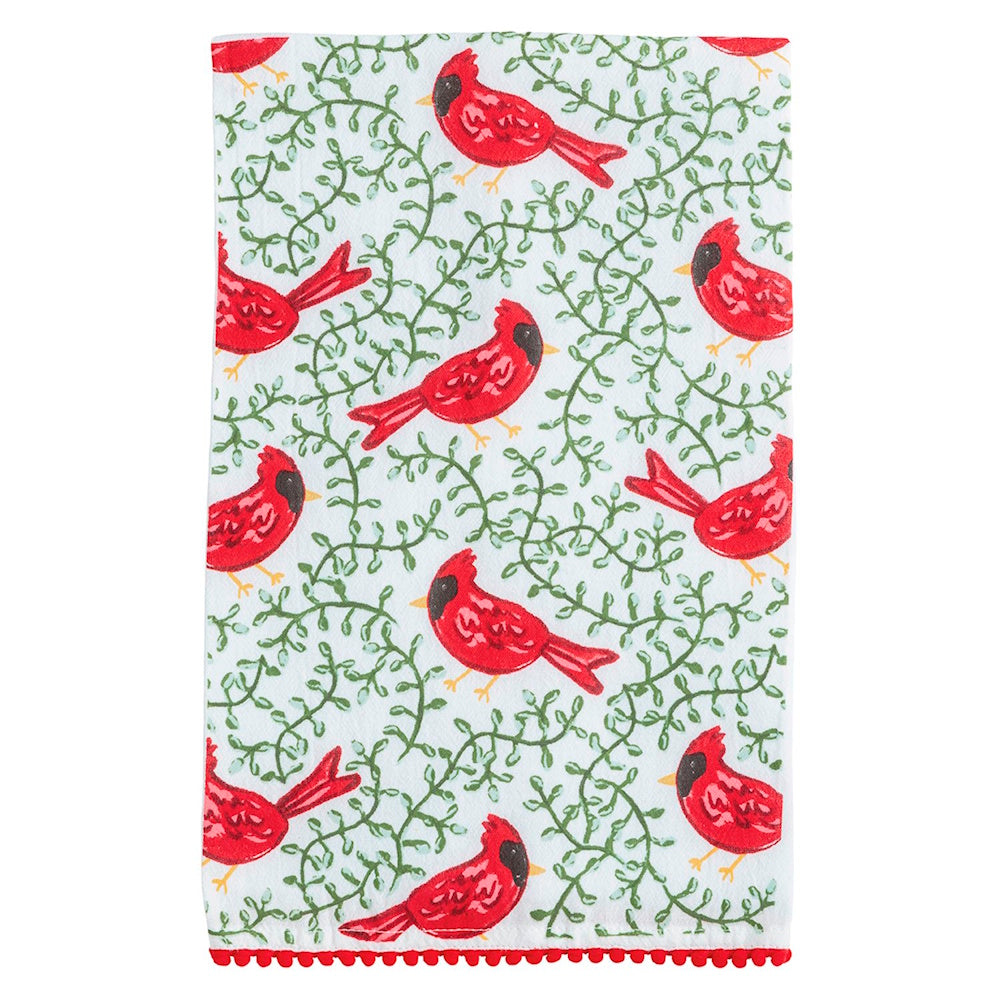 White kitchen towel featuring an all-over print of red cardinals, green vines, and pom-pom trim.
