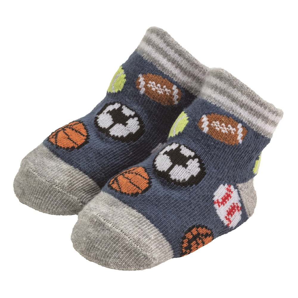 Blue baby socks with sports ball patterns including basketballs, footballs, and soccer balls with grey toes and cuffs.