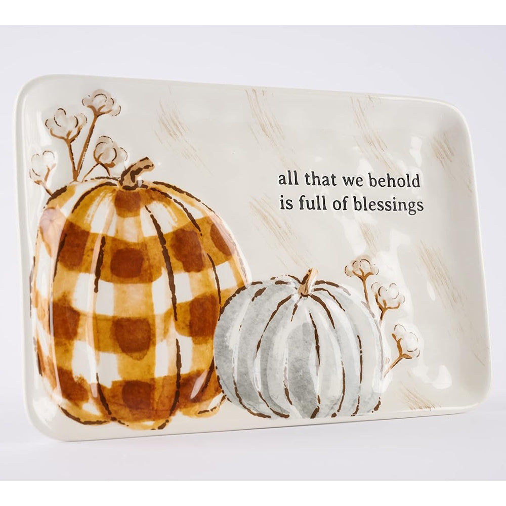 Angled side view of ceramic pumpkin sentiment tray showing text and raised design details.