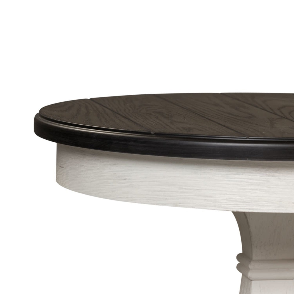 Close-up view showing the dark planked tabletop finish and white base of a round side table.