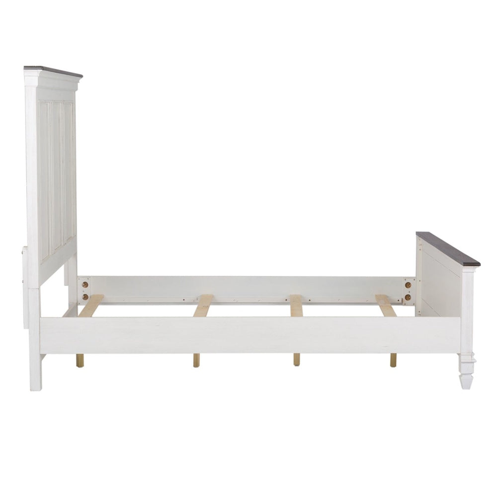Side profile view of a distressed white panel bed frame with dark top trim and wooden support slats.