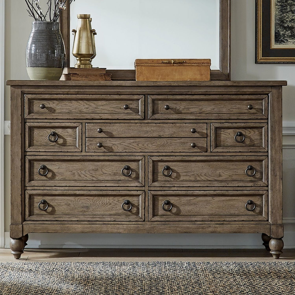 Americana farmhouse 9-drawer wooden dresser styled with a mirror and decorative items in a home setting.