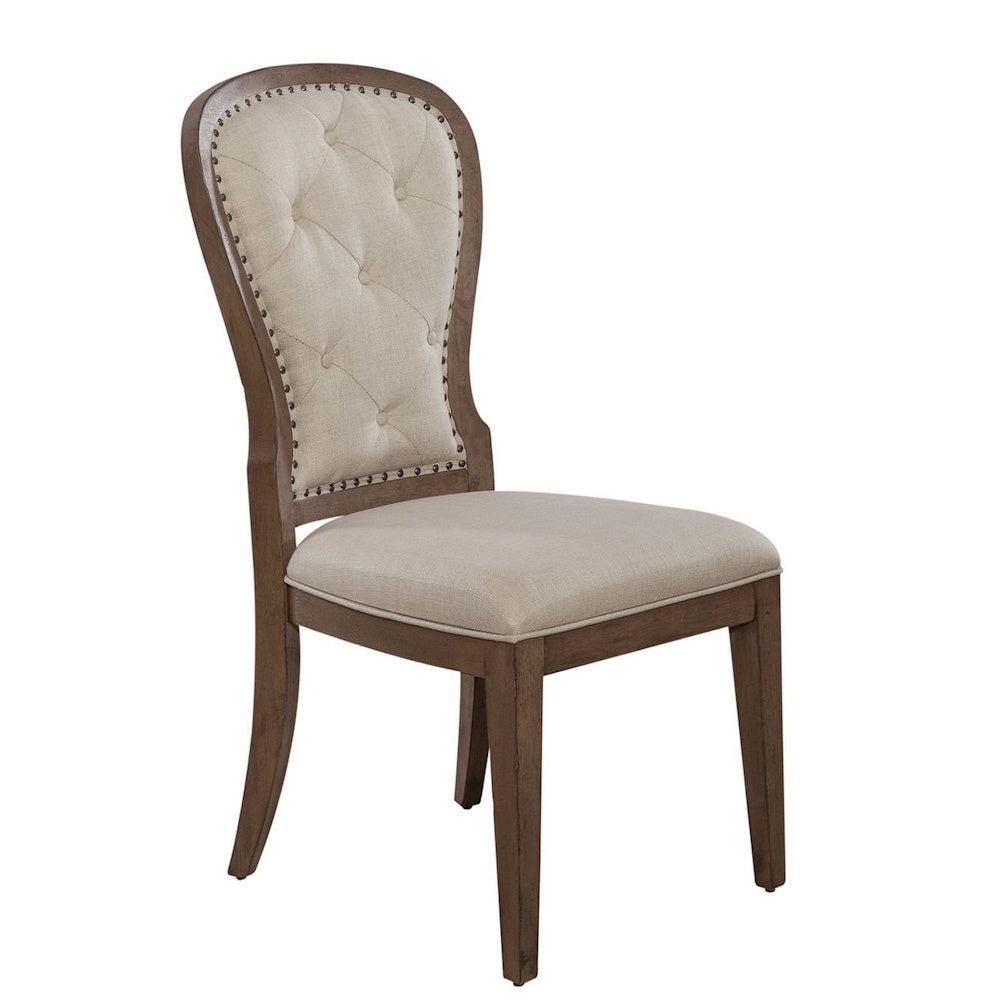 Tufted beige fabric dining chair with wooden frame and nailhead trim on a white background.