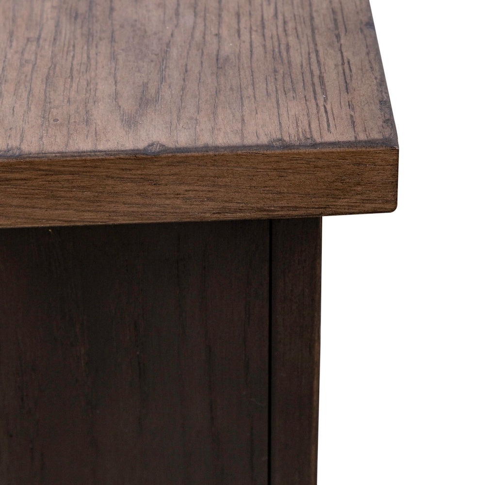 Close-up of a dark brown wooden furniture corner showing detailed wood grain texture.