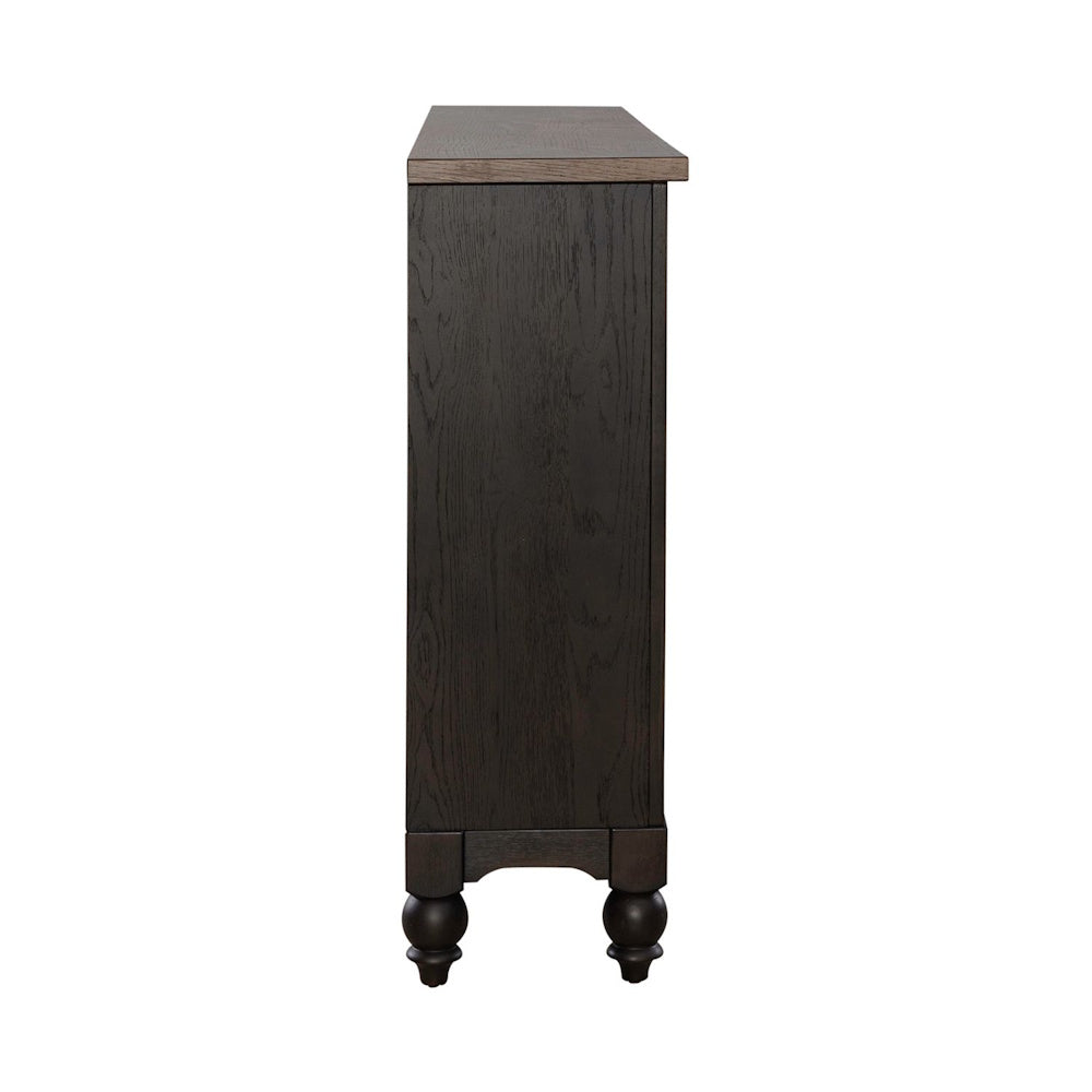 Side profile view of a dark wooden hall buffet showing its slim depth and turned feet.