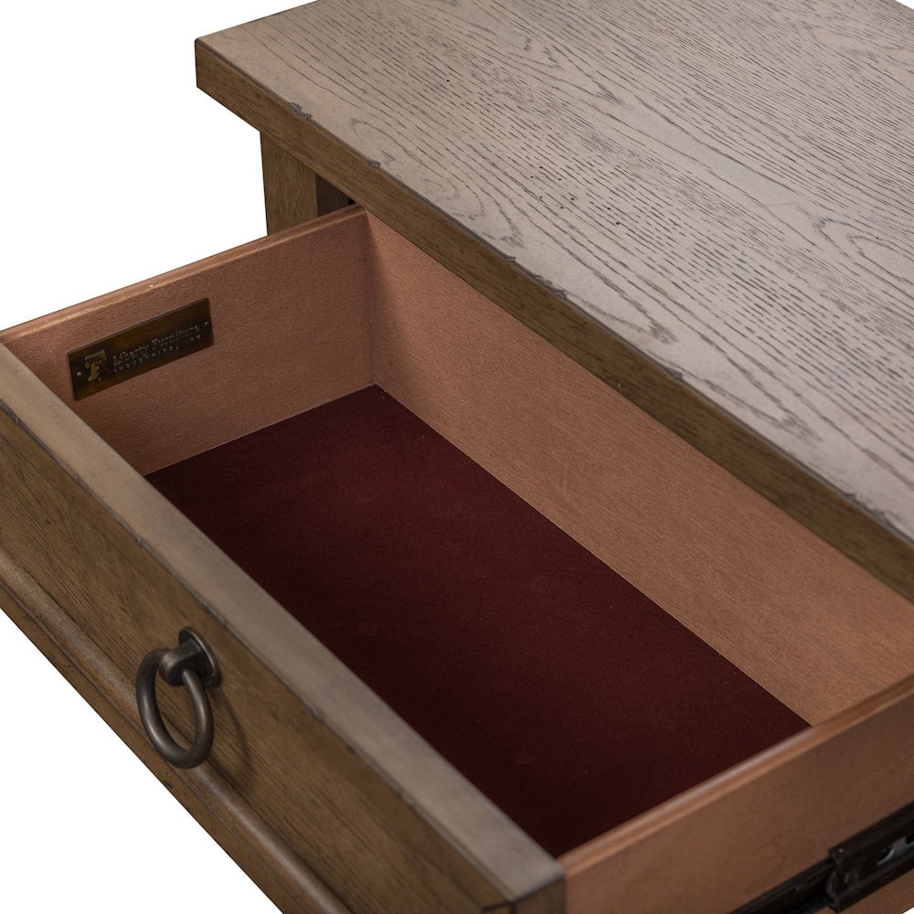 Open wooden drawer lined with brown felt, featuring a antique bronze ring pull and brand badge.