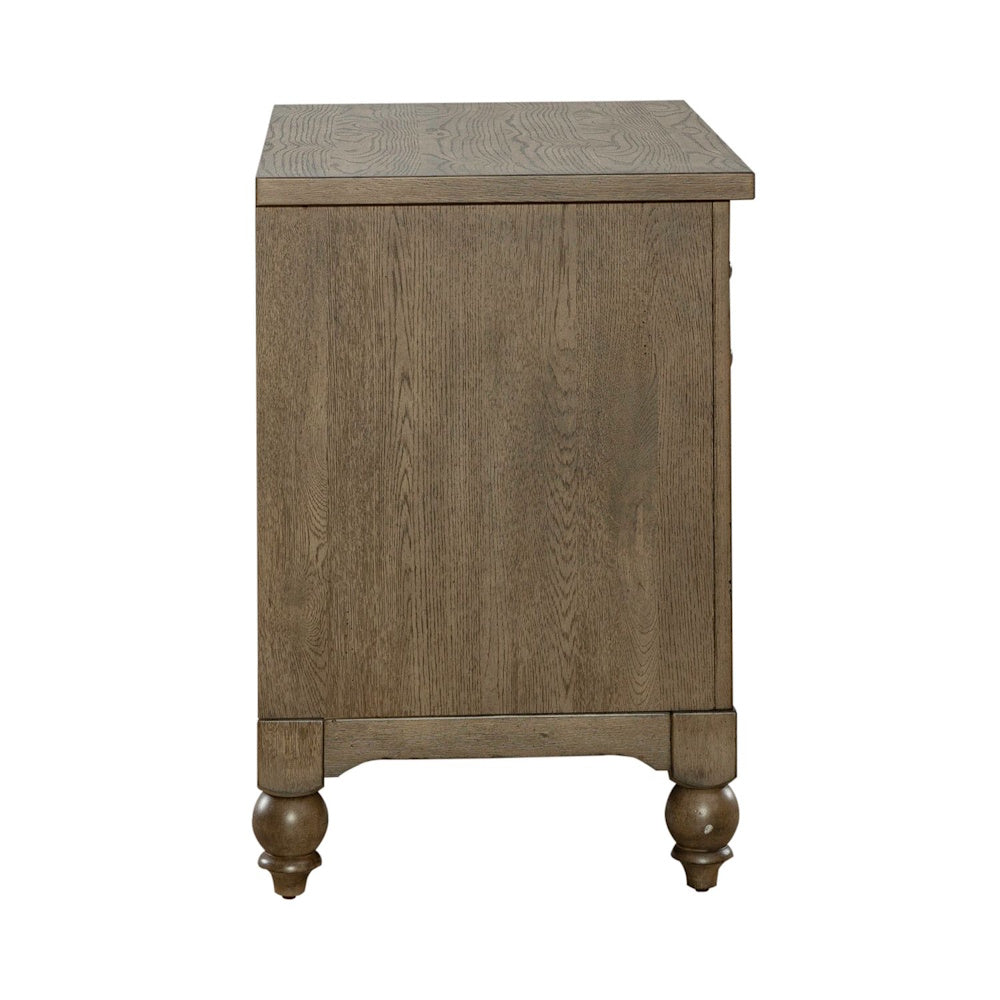 Side profile of a brown wooden lateral file cabinet showcasing smooth finish and turned bun feet.