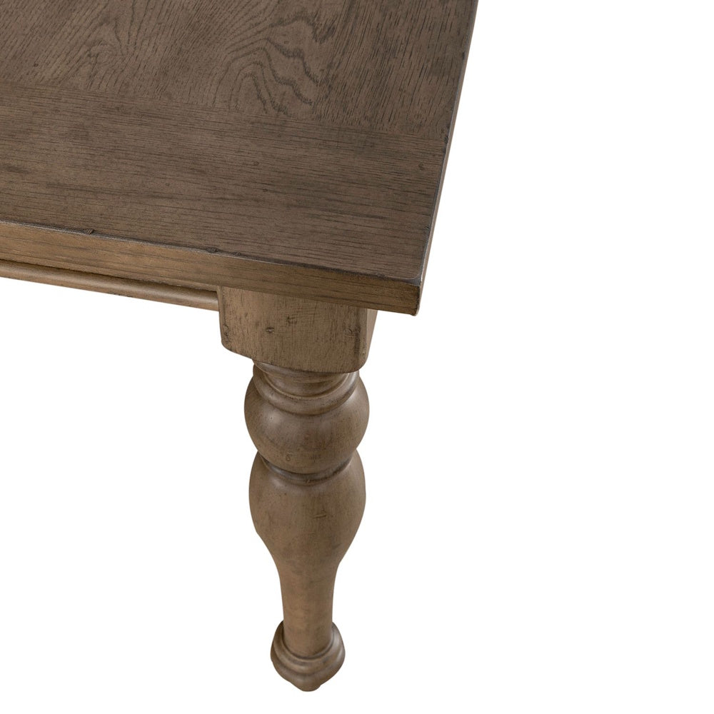 Close-up of an Americana farmhouse rectangular leg table showing the turned wood base and tabletop grain.