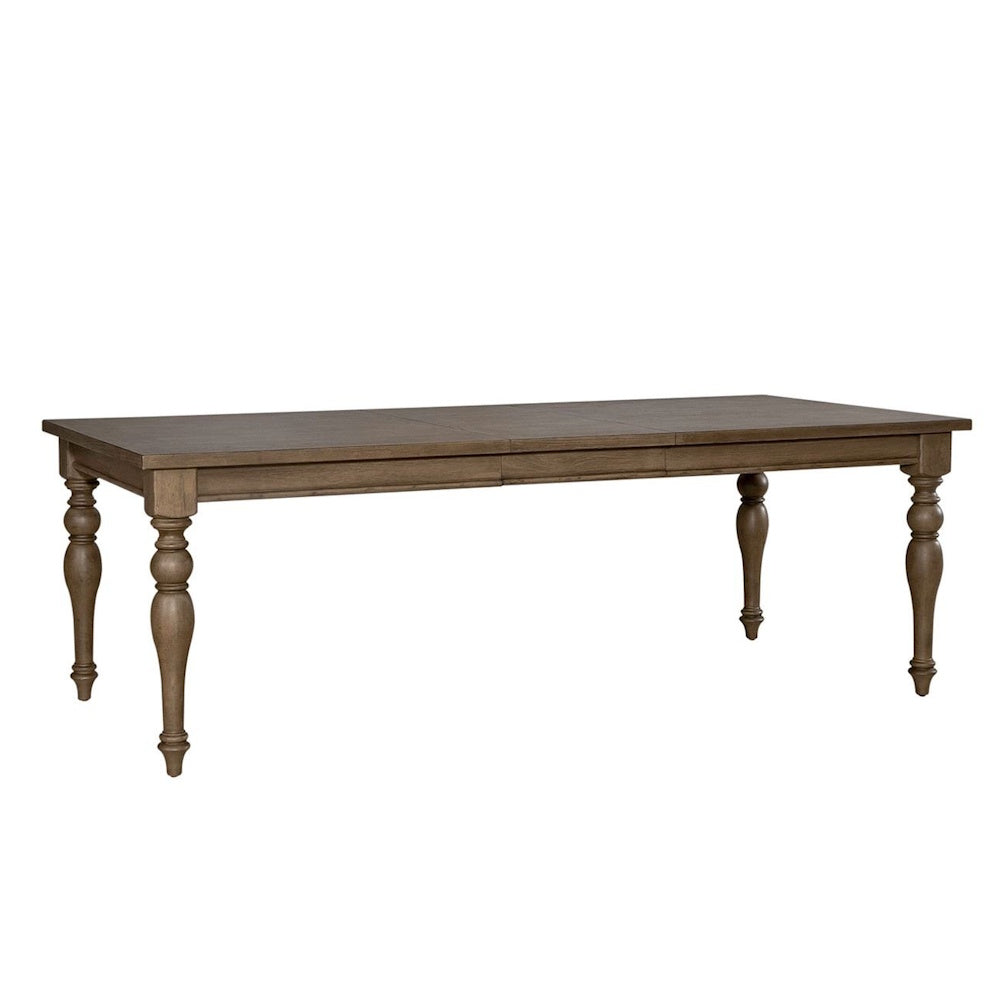Rustic wooden farmhouse dining table with carved baluster legs against a white background.