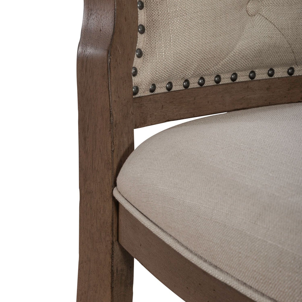 Close up side view of Americana farmhouse upholstered dining side chair with nailhead trim.
