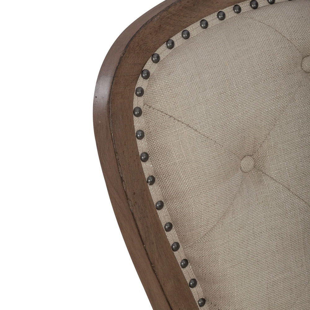 Close up of Americana farmhouse upholstered tufted back side chair with nailhead trim detail.