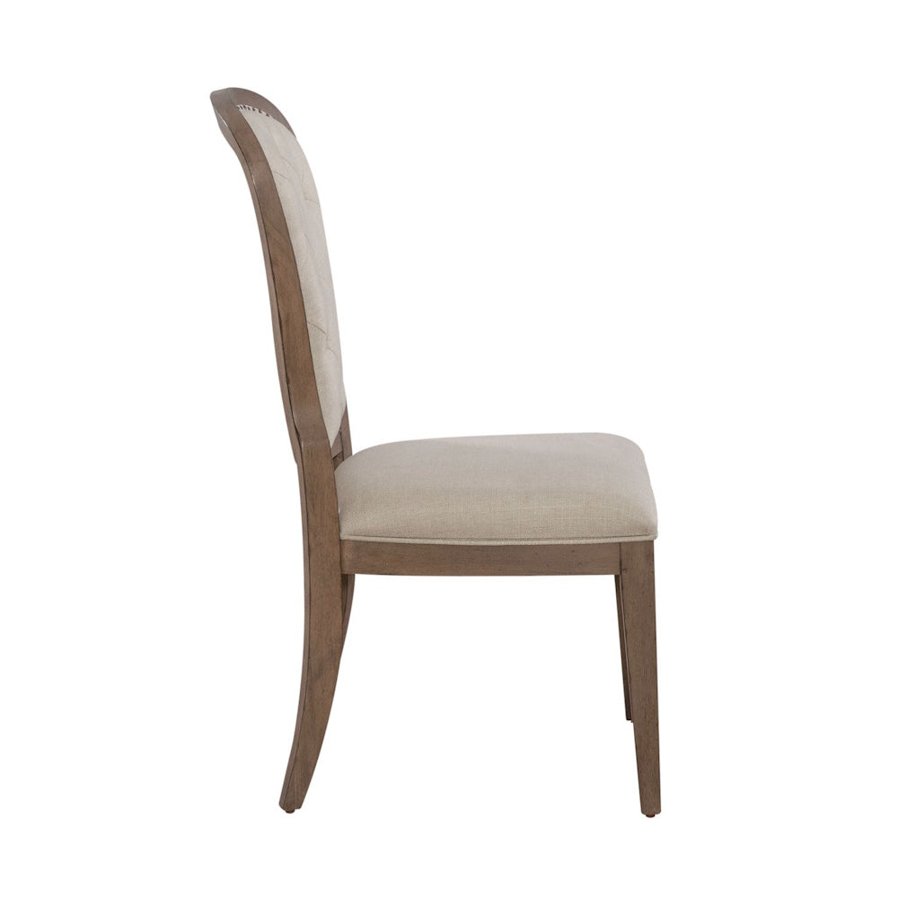 Americana farmhouse upholstered tufted back side chair shown from a side profile view with a wood frame.