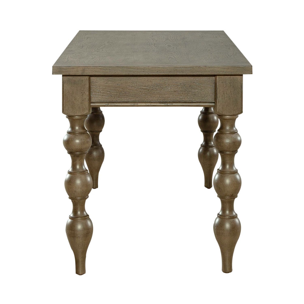 Side view of a brown wooden writing desk showcasing detailed turned spindle legs and a smooth top finish.