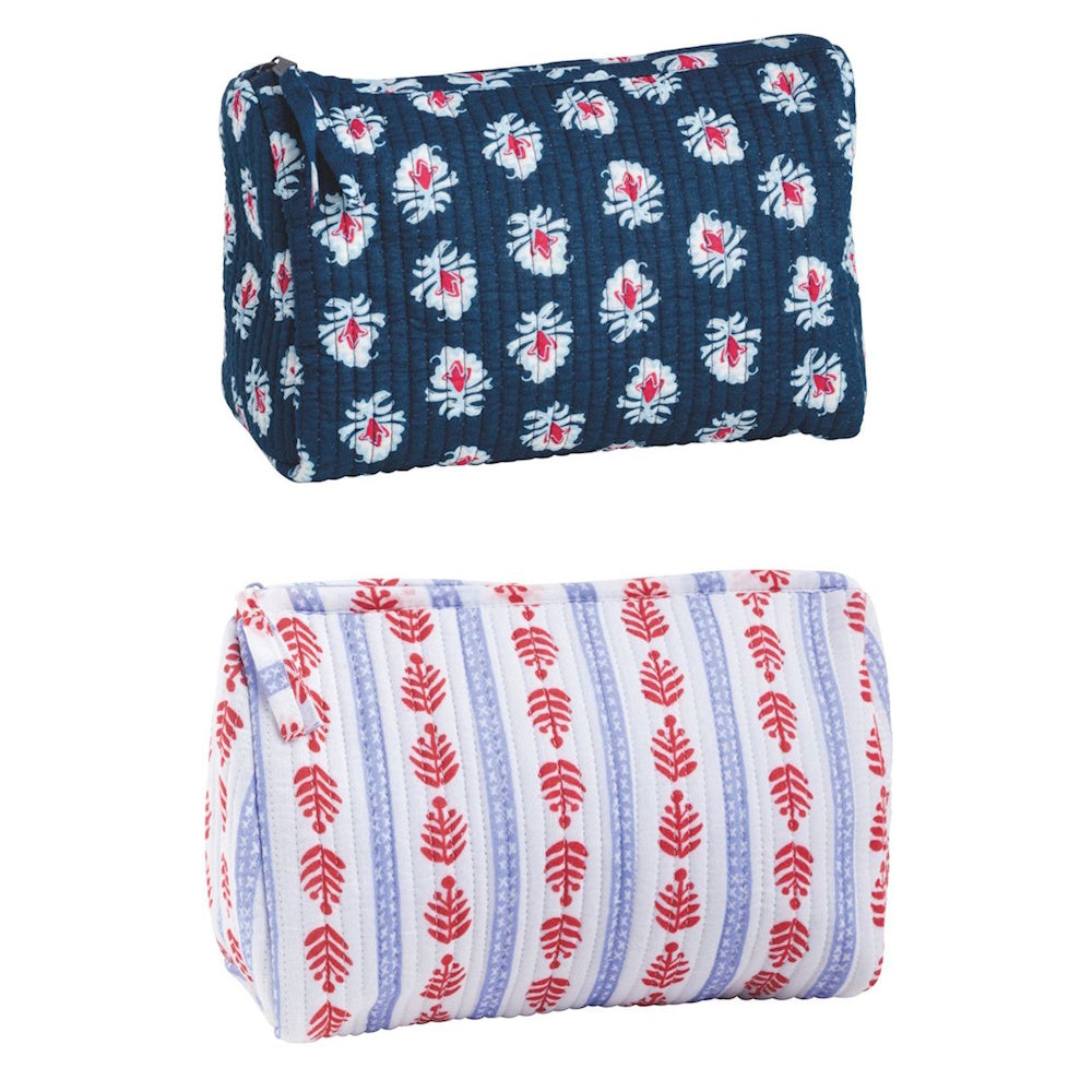 Blue and white quilted block-print toiletry bags with red floral and leaf patterns and zipper closures.