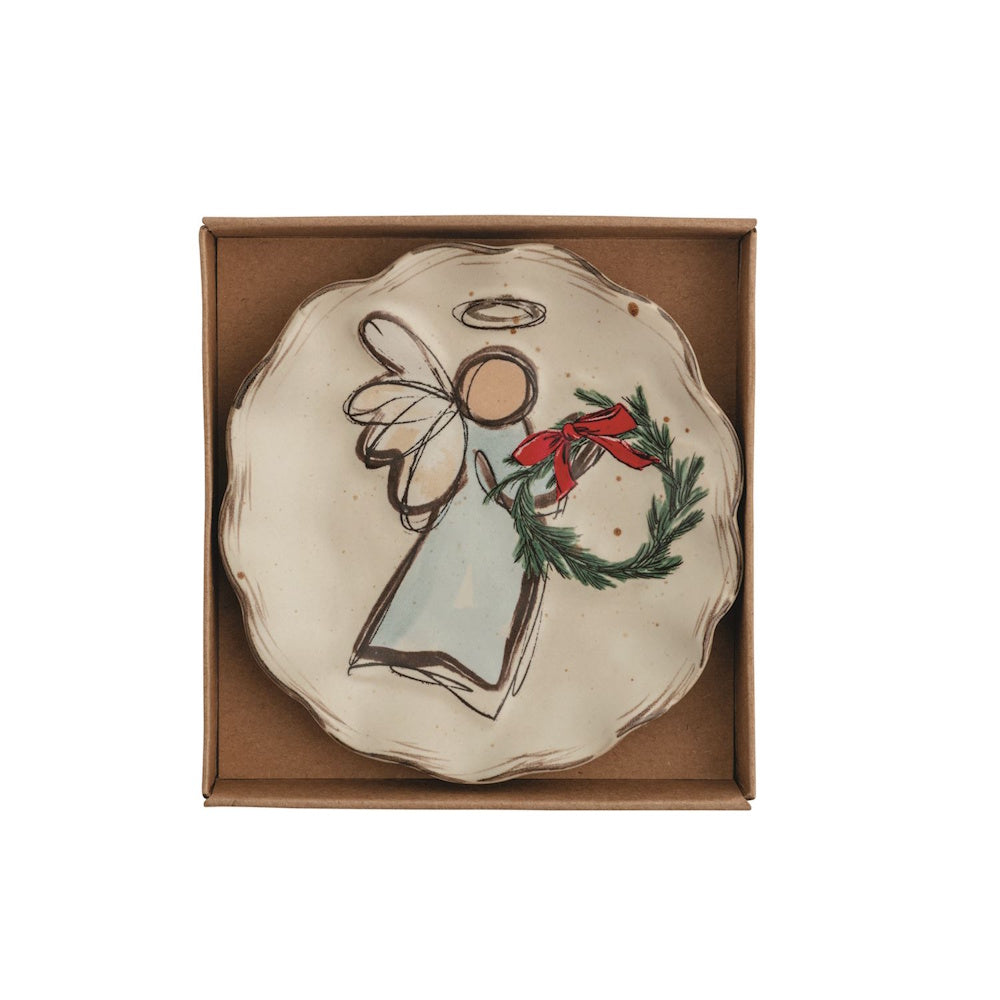 Ceramic tidbit plate in a gift box featuring an illustrated angel holding a pine wreath with a red bow.